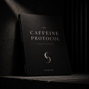 May include: A hardback book titled "The Caffeine Protocol" with silver lettering on a black cover. The book also features the text "On Stimulation and Recovery" and the logo of the brand "Somvra".
