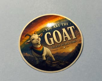 May include: Round sticker featuring a cartoon goat with a rainbow bandana and the text "YOU ARE THE GOAT GAYEST OF ALL TIME" against a sunset and rainbow background.