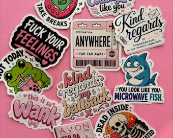 May include: A collection of eleven vinyl stickers featuring various designs and text, including a pink digital pet, a travel ticket to anywhere, a green frog with a drink, a skull holding a mug, and an Avon catalog, all with humorous phrases.
