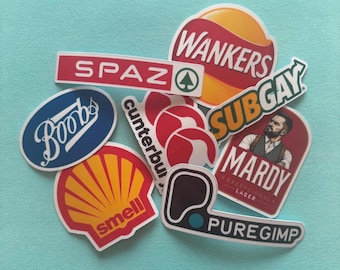 May include: A collection of vinyl stickers featuring parody logos and text including Wankers, Spaz, Subgay, Boobs, Cunterbury, Smell, Mardy, and Puregimp. The stickers are colorful with various shapes, including oval, rectangular, and custom die-cut designs.