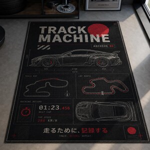 May include: A rectangular black area rug featuring a white line-art sports car in profile and top-down views. The design includes the text TRACK MACHINE ARCHIVE 09, track maps, a lap timer showing 01:23.456, top speed 288 KM/H, and Japanese text.