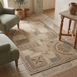 May include: A rectangular area rug featuring a multi-colored mosaic pattern of stone-like tiles in shades of beige, gray, and muted brown. The design includes geometric borders, floral motifs, and intricate scrollwork, mimicking the appearance of ancient stone flooring.