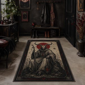 May include: A rectangular area rug featuring a detailed illustration of a horned, goat-headed figure in a hooded robe, holding a staff and a lantern. The design includes a red circular sun, celestial symbols, and a dark border with geometric accents.