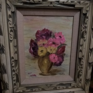 May include: A framed painting of a bouquet of pink, yellow, and purple flowers in a vase. The painting is signed "Melba" in the bottom right corner.