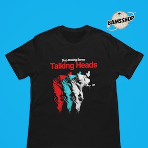 May include: A black short-sleeved t-shirt featuring a graphic print of the Talking Heads Stop Making Sense album cover. The design displays a triple-layered silhouette of a person in a suit in red, blue, and white, with the text Stop Making Sense.
