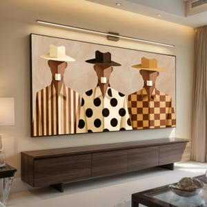 May include: A large rectangular wall art piece featuring three figures wearing hats and shirts with different patterns. The left figure wears a striped shirt, the center figure wears a polka dot shirt, and the right figure wears a checkered shirt.