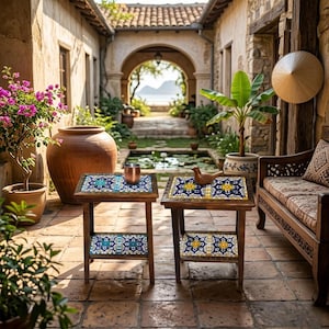 May include: Two small wooden side tables with decorative tile tops and shelves. The tiles feature blue, yellow, and white patterns. A copper cup and a wooden bird figurine sit on the tables. The tables are in an outdoor setting with a bench and plants.