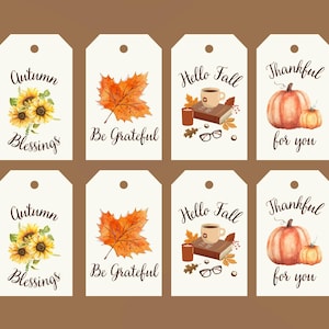 May include: Eight rectangular white gift tags with rounded top corners and a hole punch. Designs include sunflowers with 'Autumn Blessings', an orange maple leaf with 'Be Grateful', a book, mug, candle, and glasses with 'Hello Fall', and pumpkins with 'Thankful for you'.