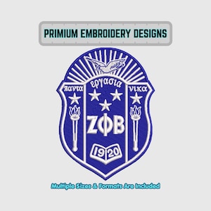 May include: A blue and white embroidered crest with the text "PRIMIUM EMBROIDERY DESIGNS" at the top. The crest features Greek text, stars, torches, and the letters "ZFB" with the year "1920". The text "Multiple Sizes & Formats Are Included" is at the bottom.