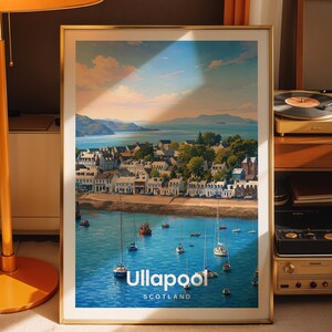 May include: A framed travel poster featuring a scenic coastal view of Ullapool, Scotland. The artwork depicts a harbor with several sailboats on blue water, a town with white buildings along the shore, and distant mountains under a soft sky.