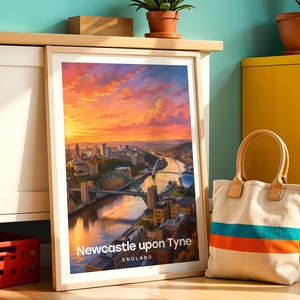 Newcastle upon Tyne poster capturing the Tyne Bridge spanning the river alongside the elegant arc of the Millennium Bridge and the warm-toned Victorian quayside facades, rendered in rich illustrative colour. Bold white NEWCASTLE typography and drifting clouds complete the composition. Oak frame leaning against a teal wall beside a white cabinet, yellow drawer unit, terracotta plant pots, a cloth bag, and a red plastic crate.