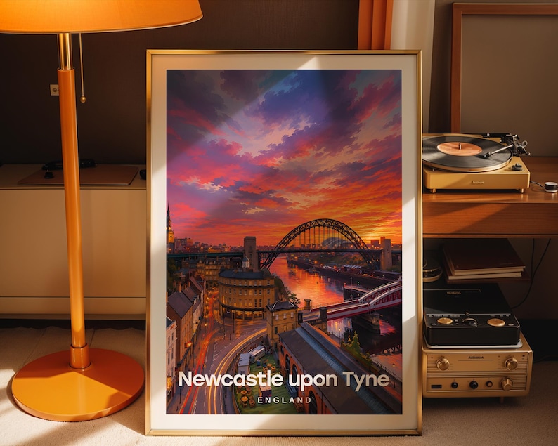 Designed as a Newcastle upon Tyne art print, this high-detail illustrated cityscape places the Tyne Bridge above the River Tyne at centre stage, with Grey Street's Georgian terraces and Grey's Monument rendered in warm layered colour and bold white NEWCASTLE UPON TYNE typography. Gold frame leaning against a dark taupe wall beside a tall floor lamp with an orange shade, a vintage record player, stacked vinyl, and terracotta curtains.