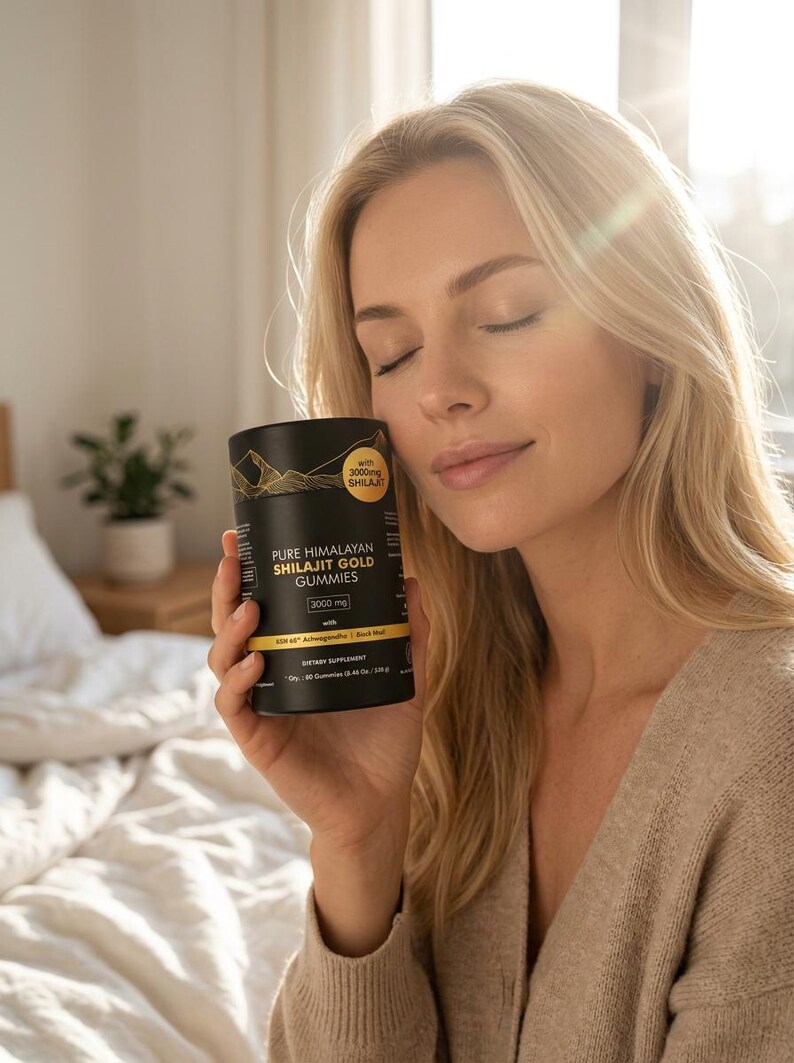 May include: A black cylindrical container of Pure Himalayan Shilajit Gold Gummies is held by a person. The container has gold lettering and a mountain graphic. The text on the container reads "3000 mg" and "Dietary Supplement".