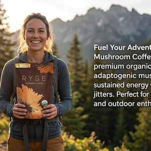 May include: A woman smiles while holding a brown package of RYSE Mushroom Coffee. The package features a sunflower design and the text "RYSE Mushroom Coffee". The background includes trees and mountains, with text that reads "Fuel Your Adventures".