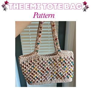 May include: A beige crochet tote bag featuring the text THE EMI TOTE BAG Pattern. The bag is constructed with a lattice-style stitch and is embellished with numerous small, multicoloured beads integrated throughout the body and the two shoulder straps.