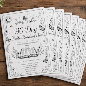 May include: A stack of white 90-day Bible reading plan booklets with black illustrations of butterflies, flowers, and moons. The cover features the text "90 Day Bible Reading Plan" and an open book illustration.