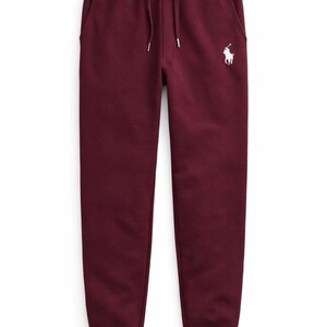 May include: Burgundy-colored sweatpants with a drawstring waist and side pockets. A white polo player logo is embroidered on the left side. The pants have a relaxed fit and cuffed ankles, suitable for casual wear.