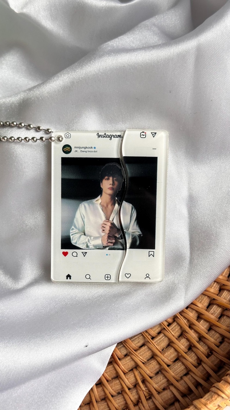 May include: A clear acrylic pendant with a silver chain, featuring a photo of a person in a white shirt, styled as an Instagram post. The pendant is split in two pieces. The Instagram logo and icons are visible.