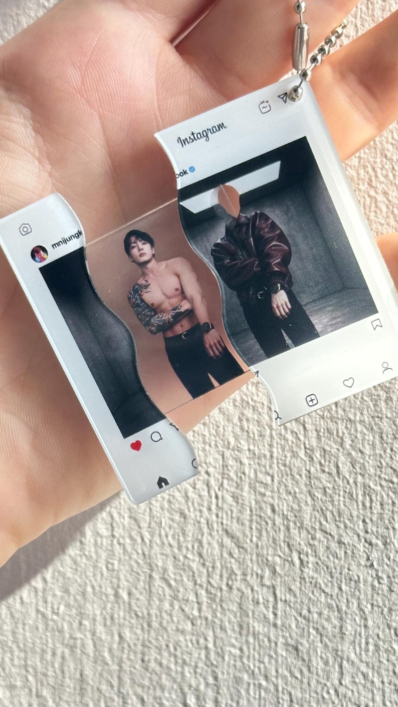 May include: A clear acrylic keychain shaped like two interlocking Instagram post frames. The left piece shows a profile icon with the text mnijungk, while the right piece displays the Instagram logo. The center features a split image of a person.