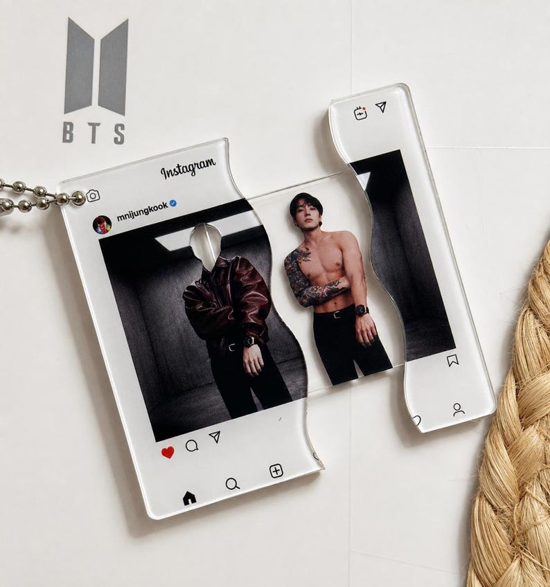May include: A clear acrylic keychain shaped like an Instagram post featuring the handle mnijungkook. The design is split into two interlocking pieces, displaying a photograph of a person in a leather jacket and a shirtless person with tattoos.