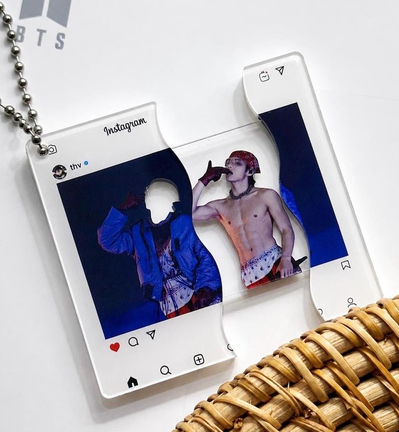 May include: A clear acrylic pendant shaped like an Instagram post interface, featuring a split design with a metal ball chain. The graphic displays a person wearing a red bandana and a blue jacket, with the username thv and Instagram icons visible.