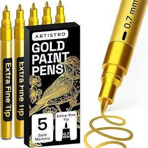 May include: Gold paint pens with extra fine tips. The black box features the text "ARTISTRO GOLD PAINT PENS" and a gold illustration of a bird. The box indicates that it contains 5 gold markers with 0.7 mm tips. The pens are gold.