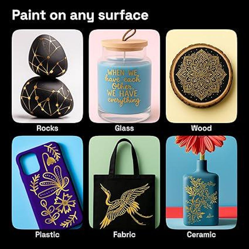May include: Image showcasing various surfaces painted with gold designs. Includes black rocks, a blue candle in a glass jar, a wooden coaster, a purple phone case, a black tote bag, and a blue ceramic vase. Text reads "Paint on any surface."
