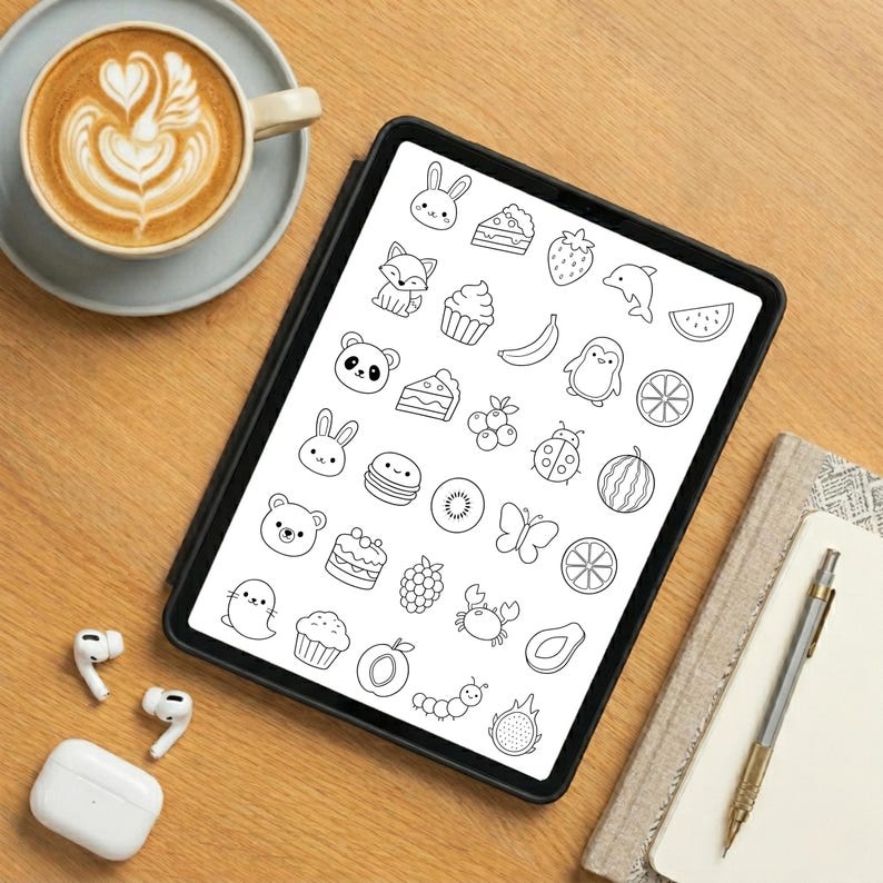 May include: A black tablet displaying a grid of black and white line art illustrations featuring various animals, fruits, desserts, and insects, including a rabbit, panda, penguin, strawberry, banana, cupcake, slice of cake, butterfly, and crab.