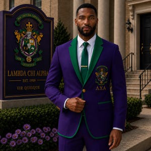 May include: A purple blazer with green lapels and trim, featuring a Lambda Chi Alpha crest on the chest and the Greek letters AXA. The blazer is worn with a white collared shirt, a green tie with a gold tie bar, and gold buttons on the sleeves.