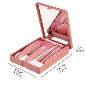 Op de afbeelding: Een roze make-up kwastenset in een compacte etui. De etui is open en onthult een spiegel en verschillende kwasten van verschillende maten. De etui is 10,7 cm lang, 8,3 cm breed en 2 cm hoog.