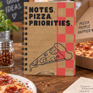 May include: A spiral-bound notebook with a kraft paper cover featuring the black text "NOTES. PIZZA. PRIORITIES." and a black line drawing of a pizza slice. The right side of the cover has a red and kraft checkered pattern.