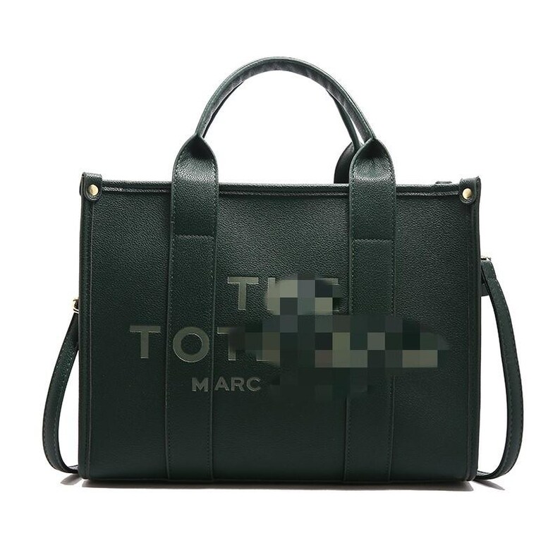 May include: A dark green tote bag with the text "THE TOTE BAG MARC" in silver lettering. The bag has two top handles and a detachable shoulder strap. The bag is rectangular in shape.