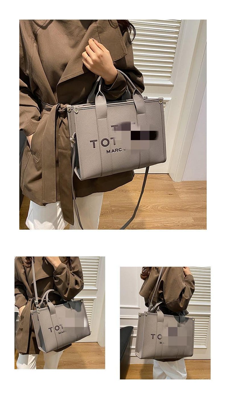 May include: Gray tote bag with top handles and a shoulder strap. The bag features the text "TOT MARC J" on the front. The bag is held by a person wearing a brown coat and white pants.