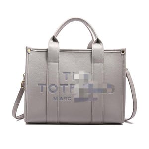May include: A gray tote bag with a top handle and a detachable shoulder strap. The bag features the word "TOTE" and "MARC" embossed on the front. The bag has gold-colored hardware.