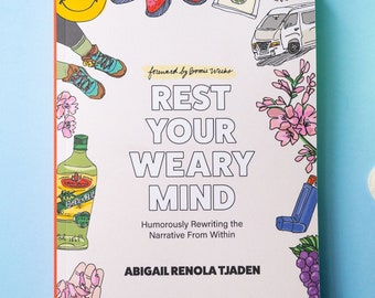 May include: A book cover with a white background and colorful illustrations. The title is "Rest Your Weary Mind" with the subtitle "Humorously Rewriting the Narrative From Within". The author is Abigail Renola Tjaden.