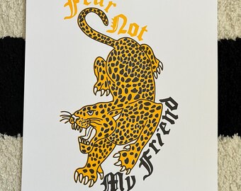 May include: A yellow and black leopard print illustration of a leopard with the text "Fear Not My Friend" in a yellow font.