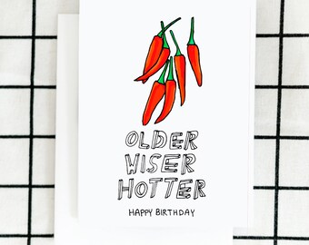 May include: A white card with a red chili pepper illustration and the text "Older Wiser Hotter Happy Birthday".