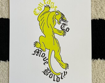 May include: A yellow panther illustration with the text "Courage to Move Boldly" in black lettering.