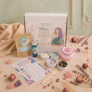 May include: A potion-making kit featuring a white box labeled The Magic Beneath the Waves, a brown pouch of mermaid fabric dust, a blue bottle of ocean potion, four small metal tins with ingredients, a pink cauldron, and a mermaid potion list.