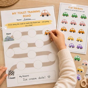May include: A laminated toilet training road chart with car stickers. The chart includes the text "My Toilet Training Road" and "Name: Emma". The chart has a road design with circles for sticker placement and instructions.