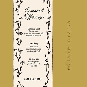May include: A cafe menu with a cream background and a gold border. The menu features the text "Seasonal Offerings" and lists three drinks: Lavender Latte, Strawberry Lemonade, and Pink Drink. The menu is decorated with floral elements.