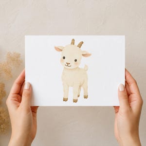 May include: A rectangular white card featuring a centred watercolour illustration of a small, cream-coloured baby goat. The goat has soft fur, small brown horns, pink-tinted cheeks, and dark eyes, standing in a simple, upright, and forward-facing pose.