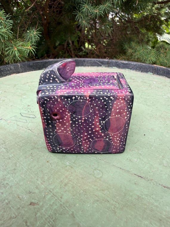 Hand-carved soapstone snake that doubles as a sliding secret puzzle box — functional folk art with a hidden compartment you have to figure out.