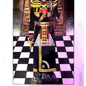 May include: An image of a man in elaborate ceremonial attire, including a tall headdress, a black robe with gold trim, and a decorative belt. The text at the bottom reads "The Supreme Grand Hierophant". The background features a black and white checkered floor.