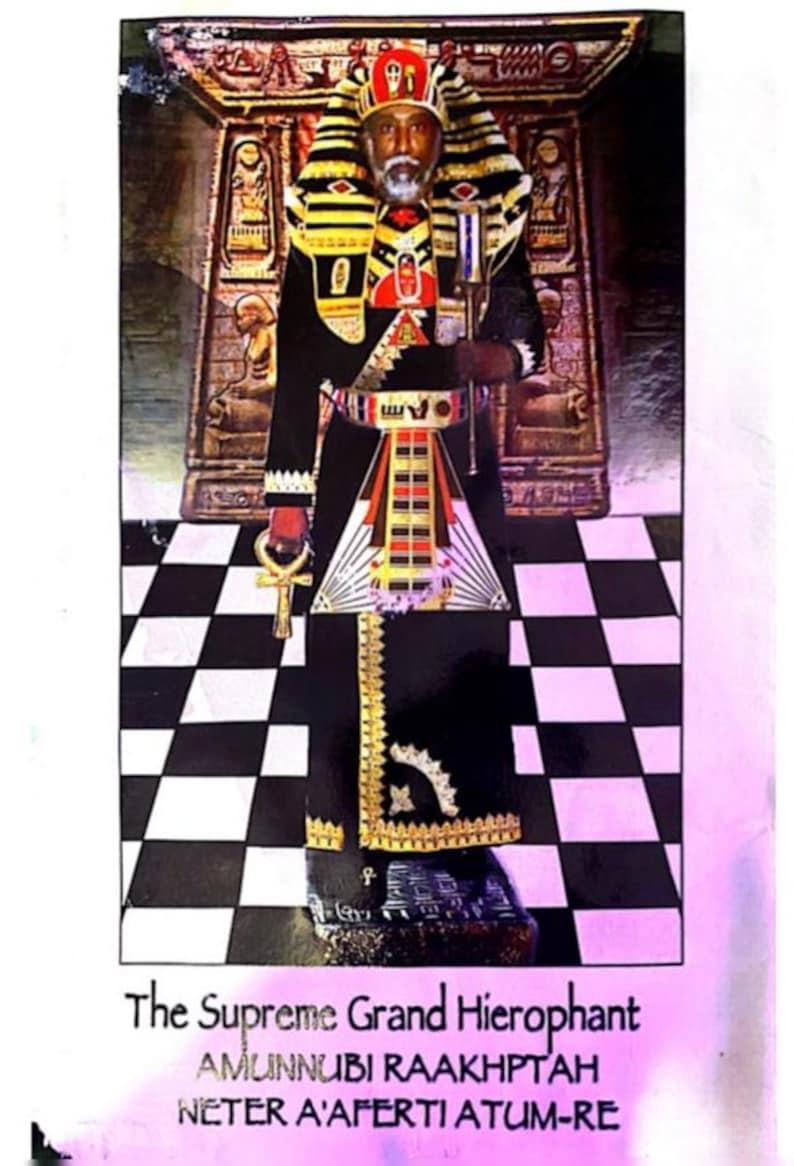 May include: An image of a man in elaborate ceremonial attire, including a tall headdress, a black robe with gold trim, and a decorative belt. The text at the bottom reads "The Supreme Grand Hierophant". The background features a black and white checkered floor.