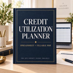 May include: A dark blue hardcover planner with gold foil text that reads CREDIT UTILIZATION PLANNER, SPREADSHEET + FILLABLE PDF, and THE 850 CREDIT SCORE PROJECT. The cover features a thin gold rectangular border and a small diamond icon.