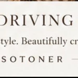 May include: A white rectangular label with dark brown text that reads COASTAL DRIVING GLOVES, followed by the text Timeless style. Beautifully crafted. and the brand name ISOTONER centered at the bottom with horizontal lines on each side.