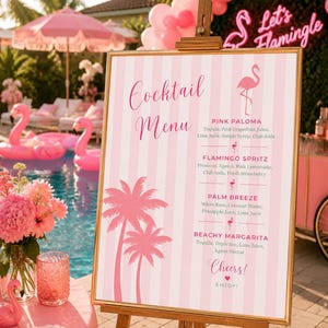 May include: A vertical rectangular cocktail menu sign with a pink and white striped background, gold frame, and wooden easel. It features pink palm tree and flamingo graphics, with text listing Pink Paloma, Flamingo Spritz, Palm Breeze, and Beachy Margarita.