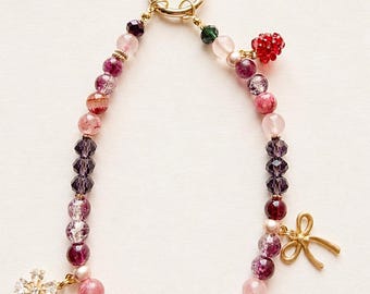 Mûrina wearable charm bracelet | Pink, raspberry and plum phone charm | Wearable wrist strap with fancy beads, gold bow and flower