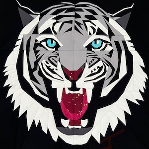 May include: A white tiger with black stripes, blue eyes, and a red mouth, is shown in a geometric paper art style.